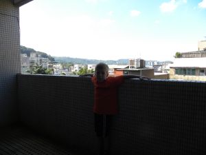 Bodhi shows off our small balcony.
